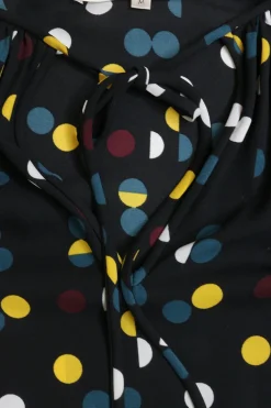 Black polyester crêpe polka dot print pullover tie neck swing-style tunic top with blouson sleeves