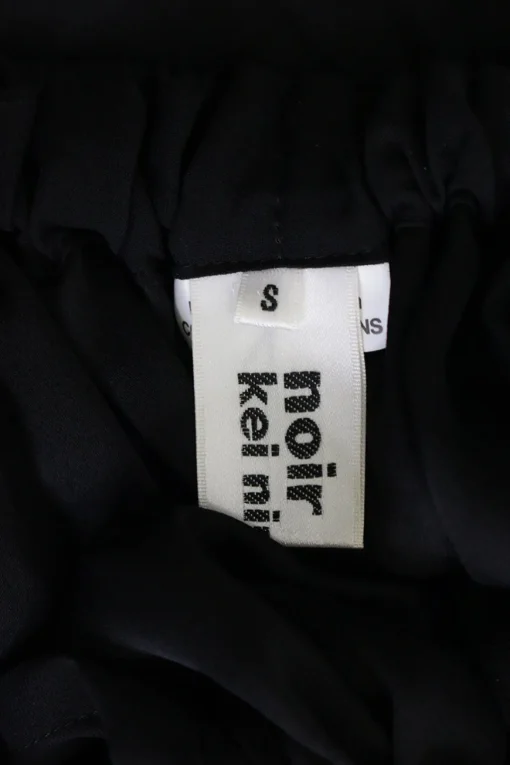 Black polyester draped buckle front harness dress overlay