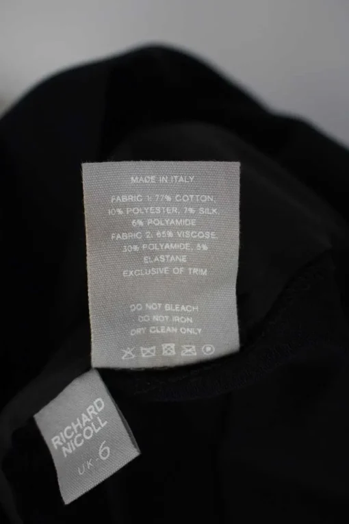 Black short sleeve shift dress with panel of off-white and black metallic fabric