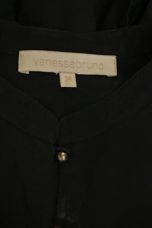 Black silk band collar half-button long sleeve tiered shift dress with metallic button loop fastening