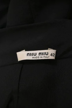 Black silk portrait neck drop-waist shift dress with knife-pleat skirt