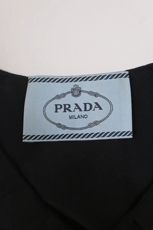 Black silk sleeveless sheath dress with frill collar and bib