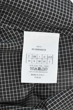 Black silk windowpane check tie-neck puff-sleeve blouse with button fastening at centre front