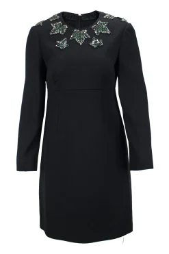 Black wool long sleeve mini dress with emerald and crystal stone embellishment around neckline, double pleated bodice for figure fit.