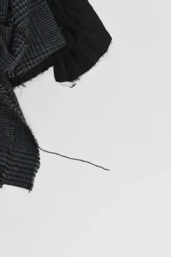 Black wool mixed-media raw edge solid and glen check tweed belted plissé knee-length skirt