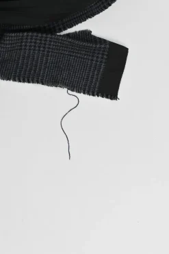 Black wool mixed-media raw edge solid and glen check tweed belted plissé knee-length skirt