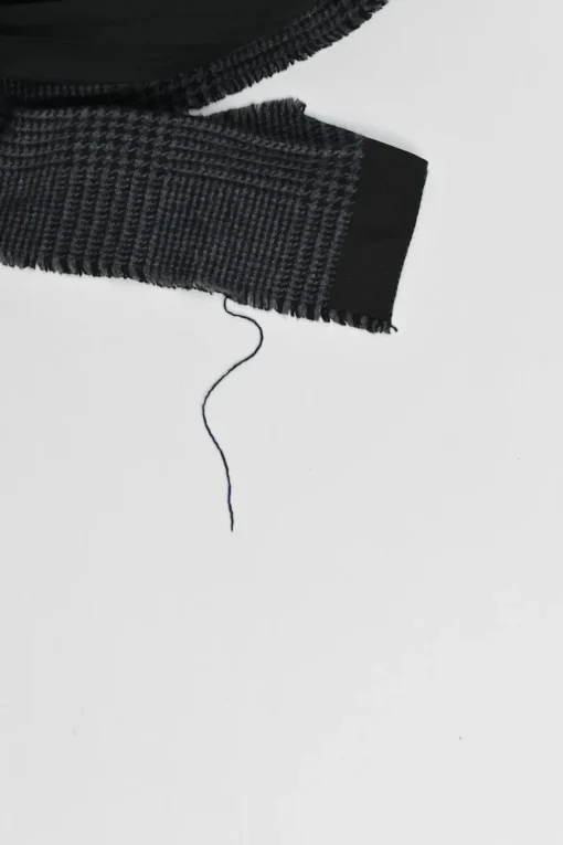 Black wool mixed-media raw edge solid and glen check tweed belted plissé knee-length skirt
