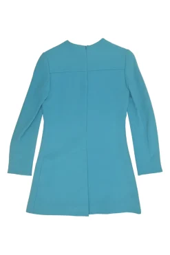 Blue long sleeve tailored blouse with chest patch, slanted hip flap pockets, and vented back