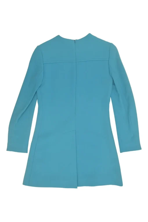 Blue long sleeve tailored blouse with chest patch, slanted hip flap pockets, and vented back