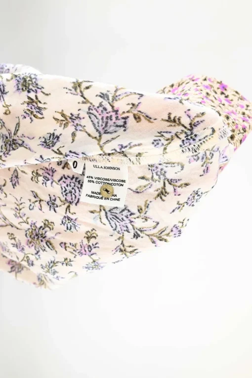 Blush and lilac paneled viscose-cotton blend ditsy floral print pullover tie-front tunic top