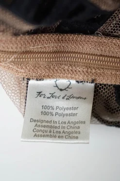 Blush sheer polyester mesh pullover boatneck top with contrasting embroidery motif