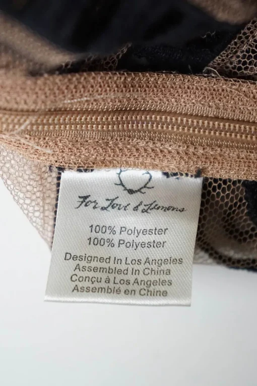 Blush sheer polyester mesh pullover boatneck top with contrasting embroidery motif