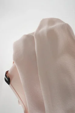 Blush silk crêpe long sleeve blouse with pleated front and blouson sleeve cuffs