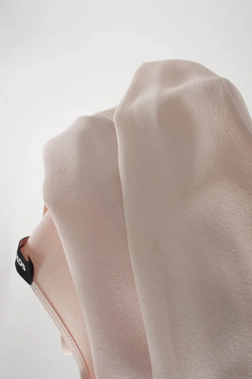 Blush silk crêpe long sleeve blouse with pleated front and blouson sleeve cuffs