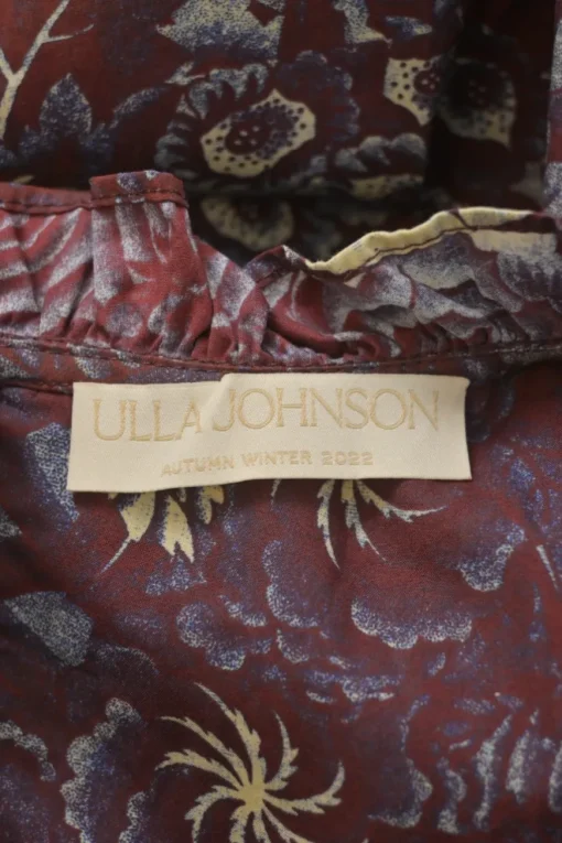 Burgundy cotton floral print ruffle keyhole-front swing-style blouse with button loop fastening at centre front