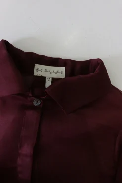 Burgundy silk organza button-front shirt with tiered ruffle sleeves and draped back panels