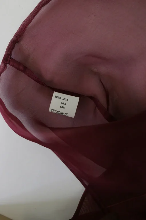 Burgundy silk organza button-front shirt with tiered ruffle sleeves and draped back panels