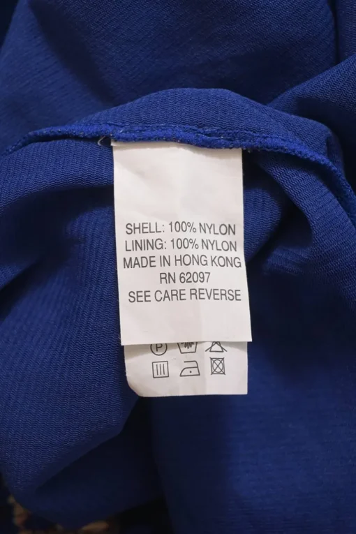 Cobalt blue shirred nylon mock neck long sleeve blouse featuring abstract motif