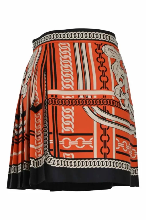Coral and black silk chainlink foulard print apron-style pleated mini skirt with horsebit-trimmed waist