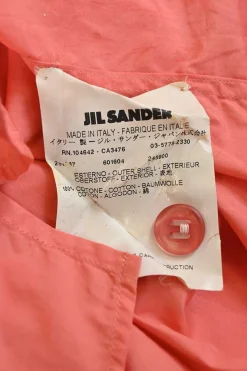 Coral cotton half-button polo-style utility shirt with classic collar