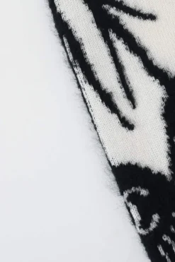 Cream and black cashmere-silk blend crewneck intarsia knit sweater featuring floral Coco Mark sleeve motif