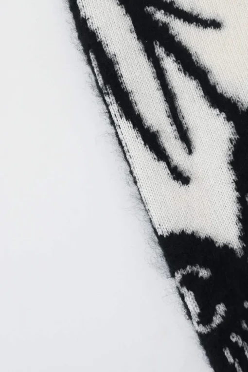 Cream and black cashmere-silk blend crewneck intarsia knit sweater featuring floral Coco Mark sleeve motif