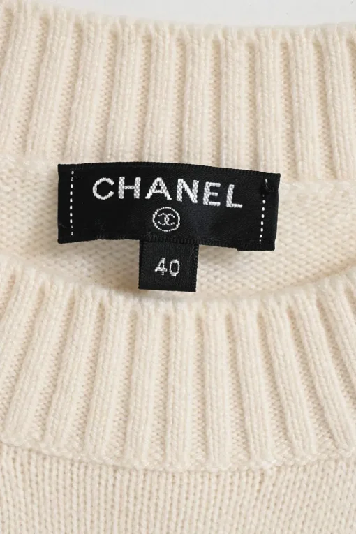 Cream and black cashmere-silk blend crewneck intarsia knit sweater featuring floral Coco Mark sleeve motif