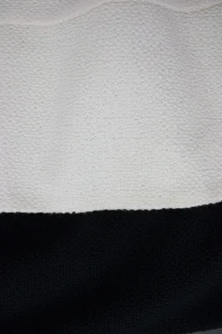Cream and black wool layered mid-sleeve knee-length dress. feature zipper fastening at the back.