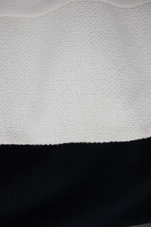 Cream and black wool layered mid-sleeve knee-length dress. feature zipper fastening at the back.