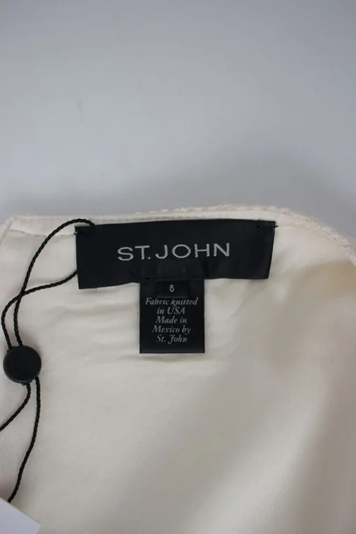 Cream and black wool layered mid-sleeve knee-length dress. feature zipper fastening at the back.