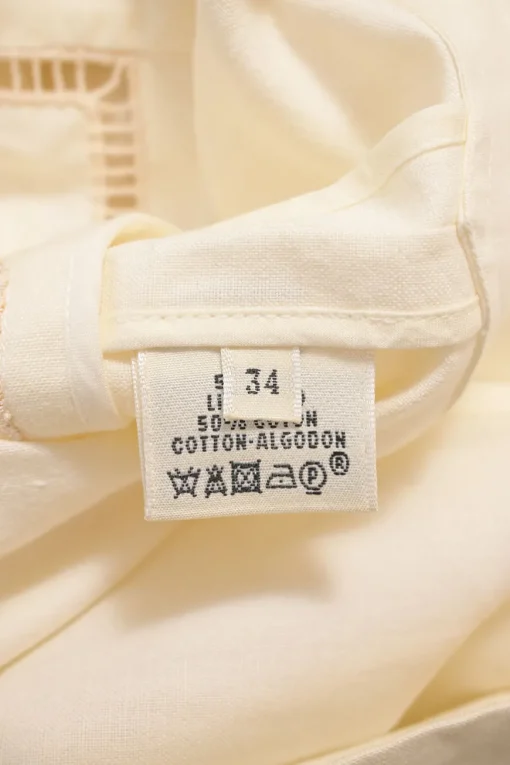 Cream bias-cut paneled linen-blend tunic shift featuring bateau neck, kimono sleeves, and cutout edge trim appliqué