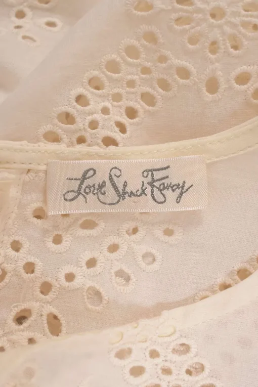 Cream cotton broderie Anglaise button-back long sleeve ruffled blouse