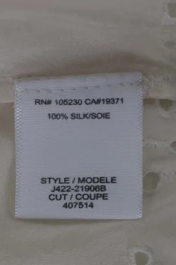 Cream sleeveless silk top with broderie hem