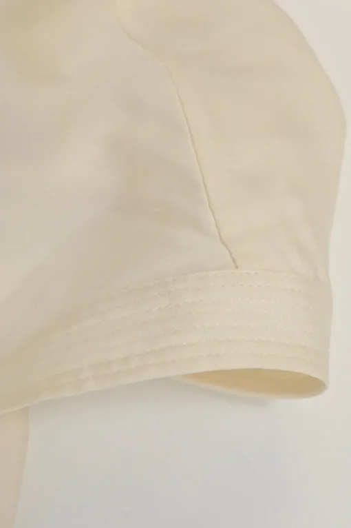 Cream Y-collar plunge neck pullover blouse with button tab sleeves