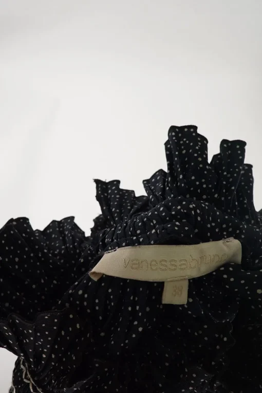 Dark navy polyester dot print smocked swing-style high collar blouse with flounce cuffs