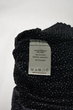 Dark navy polyester dot print smocked swing-style high collar blouse with flounce cuffs