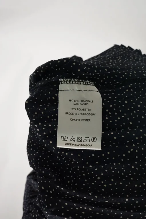 Dark navy polyester dot print smocked swing-style high collar blouse with flounce cuffs