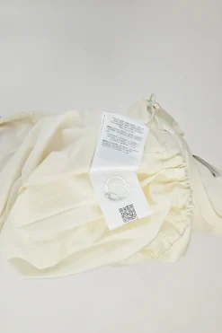 Ecru cotton and polyester mixed-media crewneck pullover T-shirt with lace insert and toggle hem