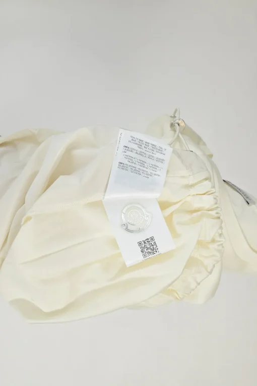 Ecru cotton and polyester mixed-media crewneck pullover T-shirt with lace insert and toggle hem