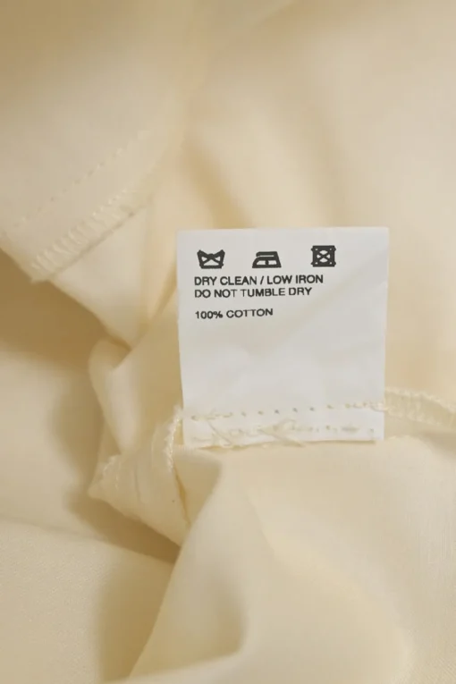 Ecru cotton plunge neck bishop sleeve blouse with frame-defining princess seams