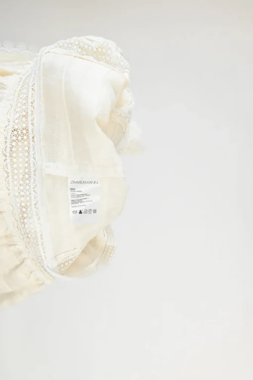 Ecru linen shirtwaist-style pintuck high-collar peplum blouse with tonal lace inserts