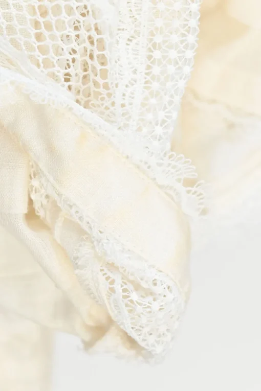 Ecru linen shirtwaist-style pintuck high-collar peplum blouse with tonal lace inserts