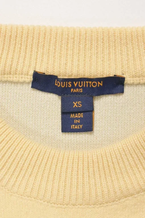 Ecru wool-blend crewneck pullover sweater with zip cuffs and monogram flower binding detail