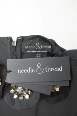 Grey short sleeve knee length shift dress with ruffled hem and crystals embellishment on the front neckline
