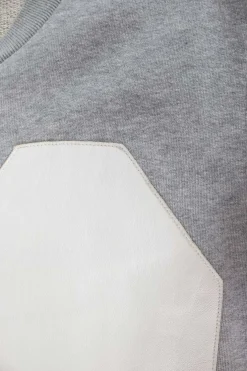 Grey sleeveless top with white leather patches