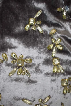 Grey velvet luster sleeveless mini dress with gathered knots and adorned with yellow jewel beads