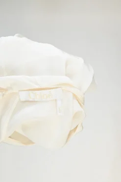 Iconic milk silk flutter sleeve capelet blouse