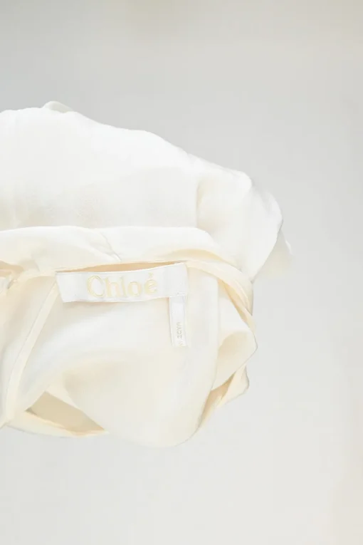 Iconic milk silk flutter sleeve capelet blouse
