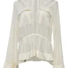 Iconic Milk viscose lace shirtwaist-style high-collar peek-a-boo peplum blouse with ribbon-tie fastening at waist