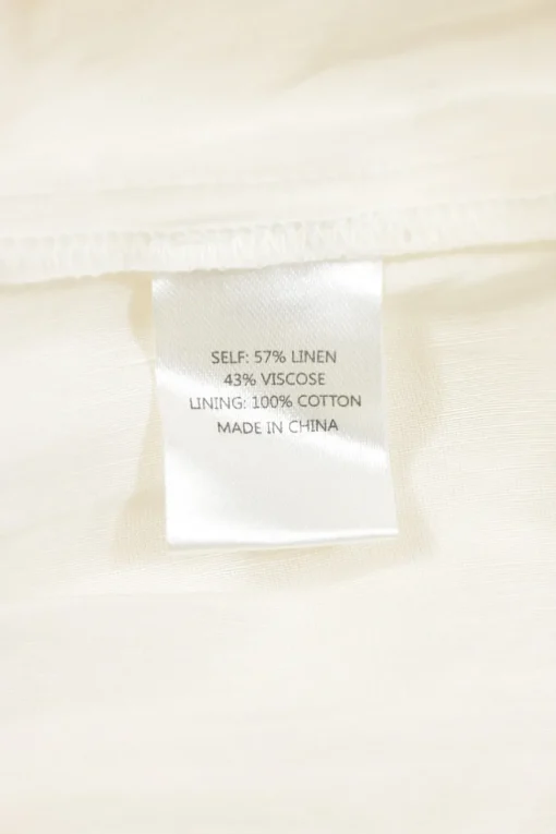 Ivory bias-cut linen-blend plunge neck flutter sleeve tiered maxi dress with open back and ribbon-tie fastening at nape